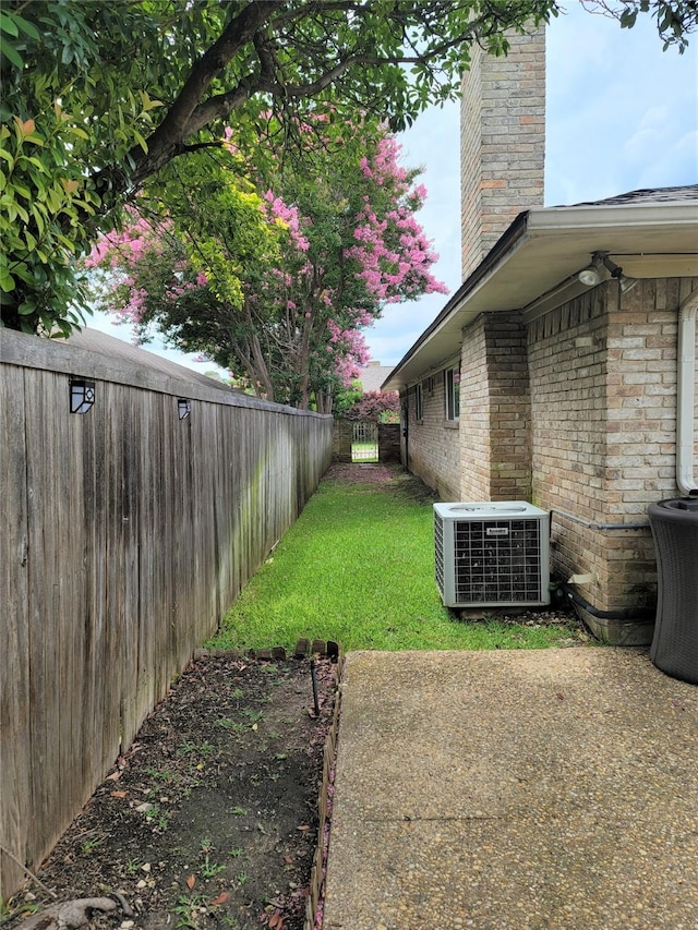 view of yard featuring a patio and central AC