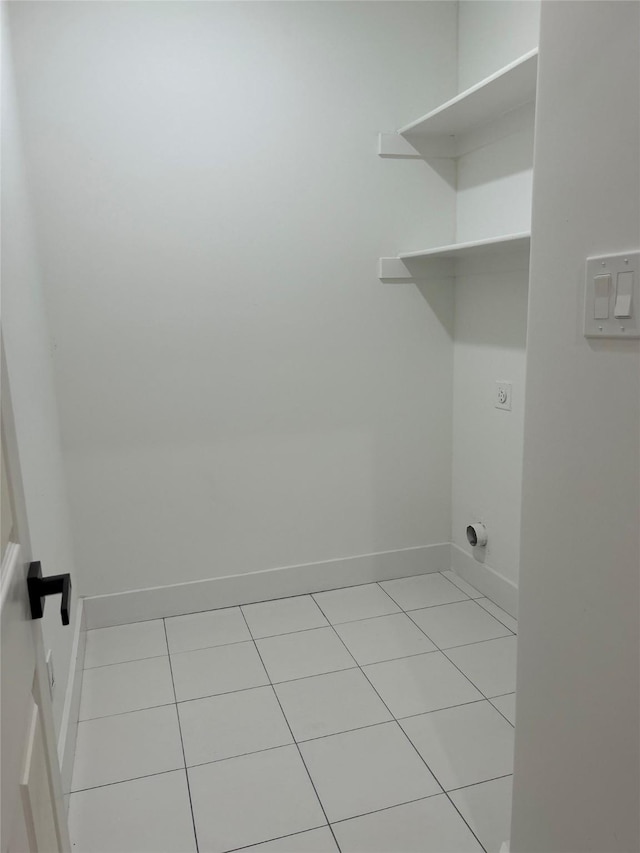 laundry area featuring light tile patterned flooring and electric dryer hookup