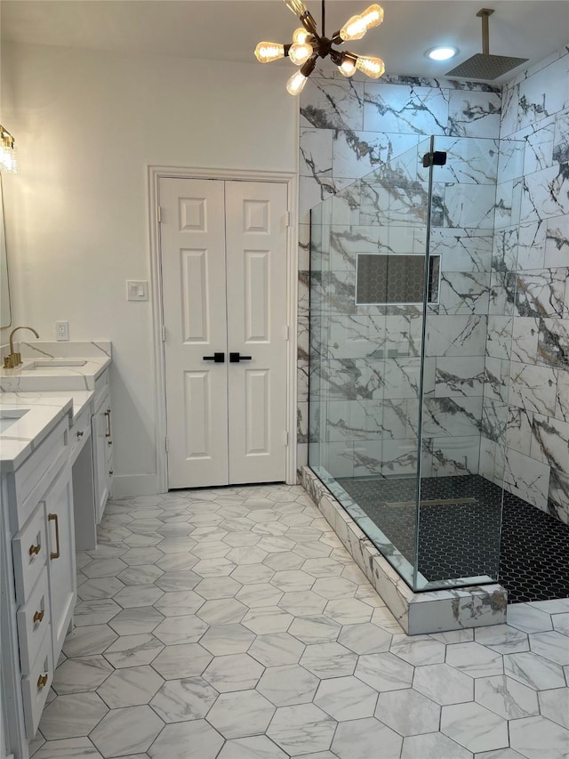 bathroom with a shower with shower door, vanity, and a notable chandelier