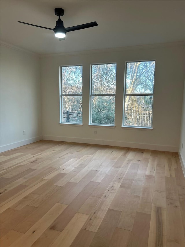 spare room featuring ceiling fan, crown molding, and light hardwood / wood-style floors