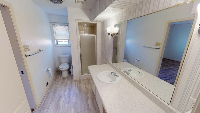 bathroom with toilet, vanity, and walk in shower