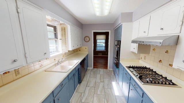 kitchen featuring blue cabinetry, white cabinets, sink, and stainless steel appliances