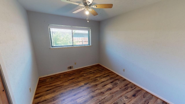 unfurnished room featuring ceiling fan and dark hardwood / wood-style floors