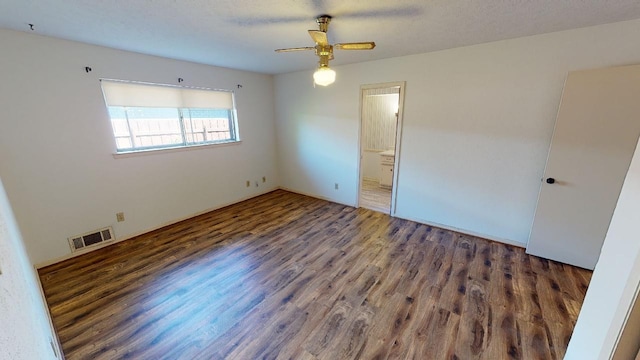 unfurnished bedroom featuring a textured ceiling, ceiling fan, dark hardwood / wood-style flooring, and connected bathroom