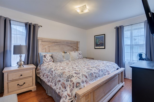 bedroom featuring dark hardwood / wood-style floors and multiple windows