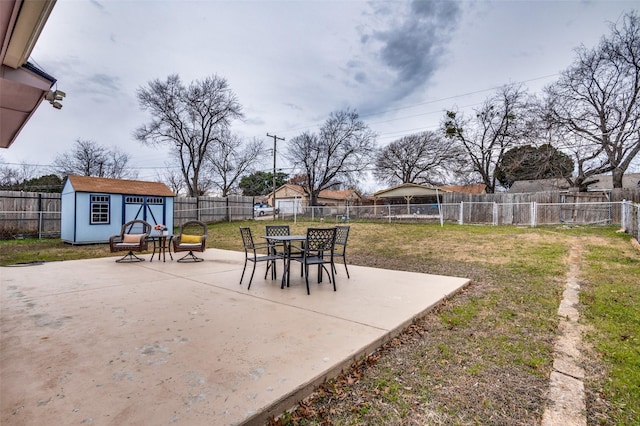 view of yard featuring a storage unit and a patio