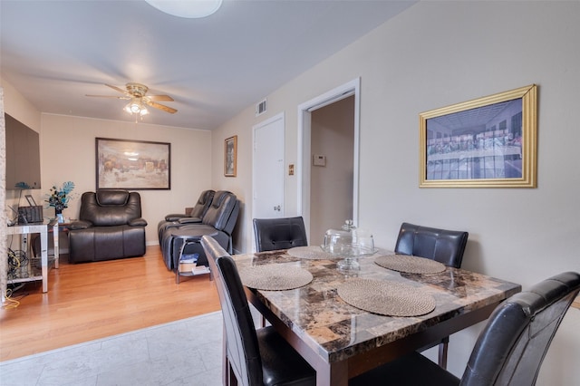 dining room with ceiling fan and light hardwood / wood-style floors