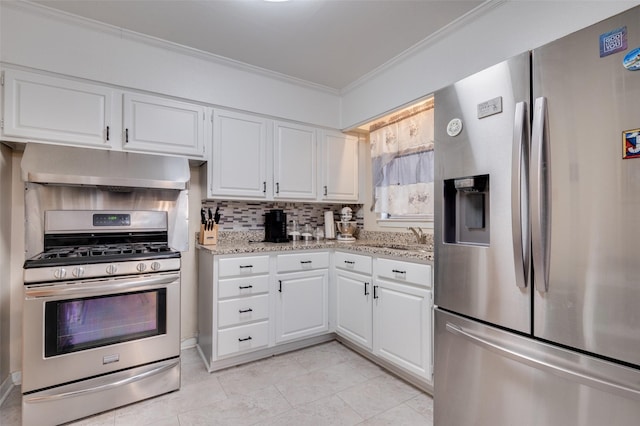 kitchen featuring appliances with stainless steel finishes, white cabinetry, and light stone counters