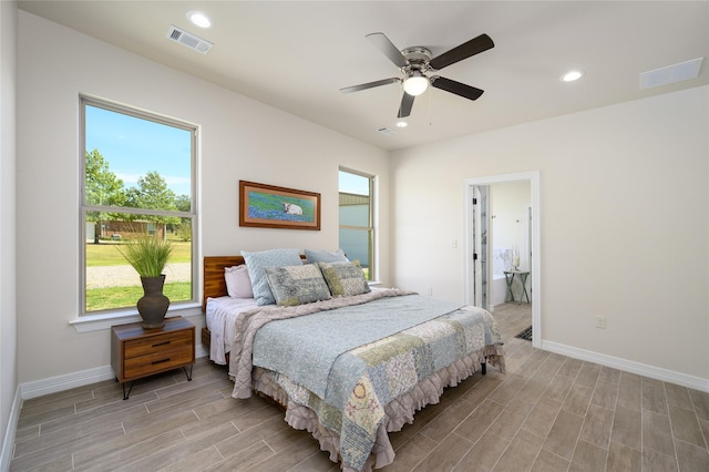 bedroom featuring wood tiled floor, visible vents, baseboards, and recessed lighting