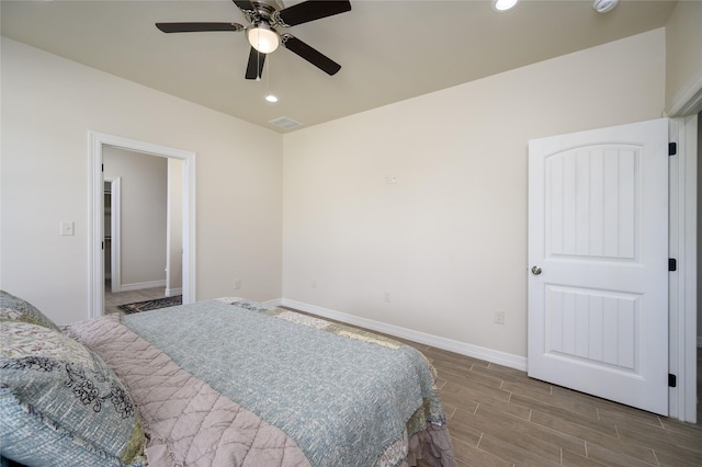 bedroom featuring ceiling fan, recessed lighting, wood finished floors, visible vents, and baseboards