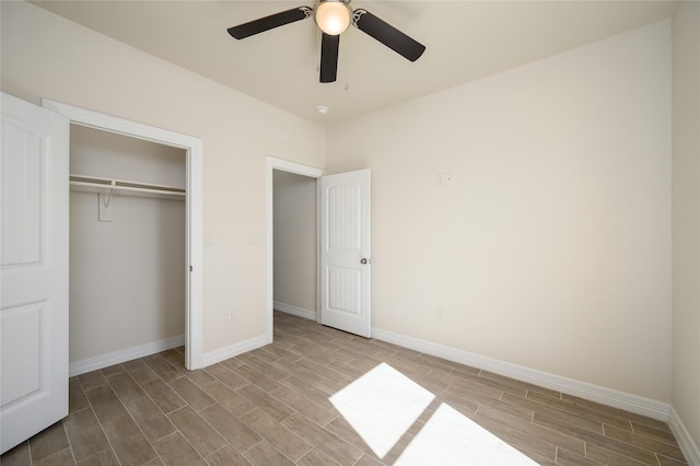 unfurnished bedroom featuring a ceiling fan, a closet, baseboards, and wood finished floors