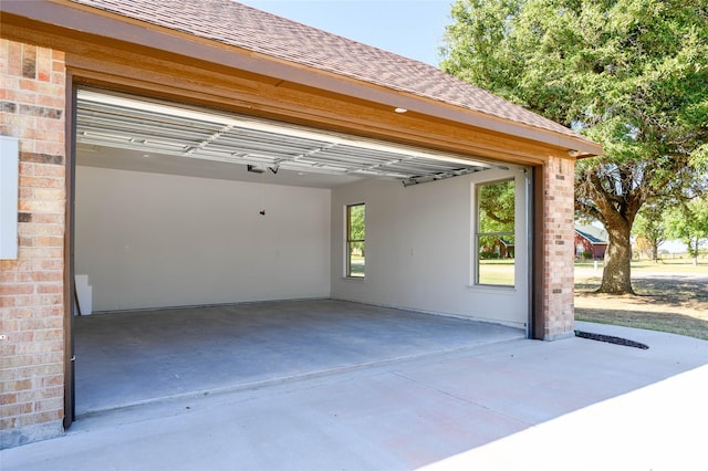 garage featuring concrete driveway