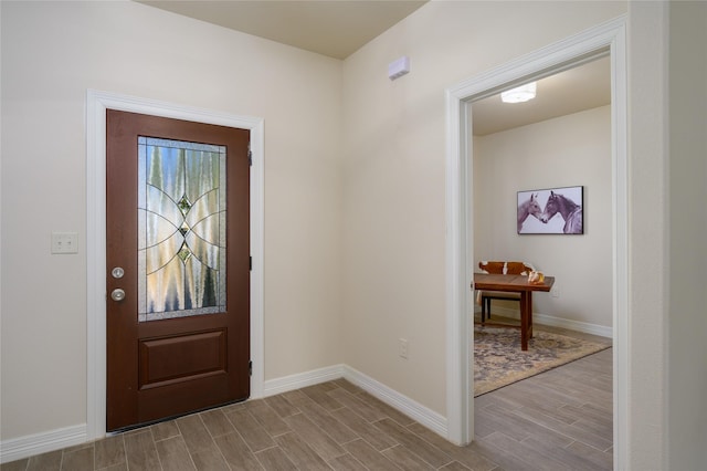 entryway featuring wood finish floors and baseboards