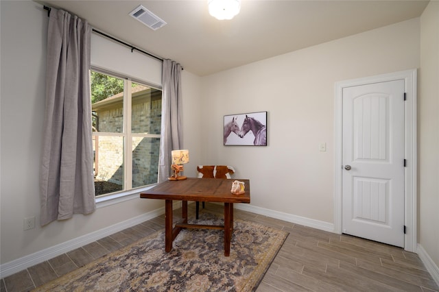 home office featuring baseboards, visible vents, and wood finish floors