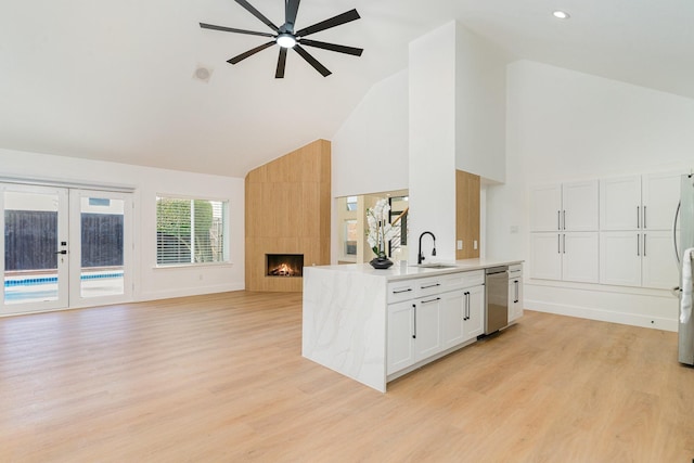 kitchen with sink, appliances with stainless steel finishes, ceiling fan, light hardwood / wood-style floors, and white cabinets