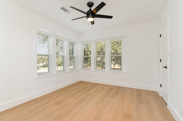 unfurnished sunroom with a wealth of natural light and ceiling fan