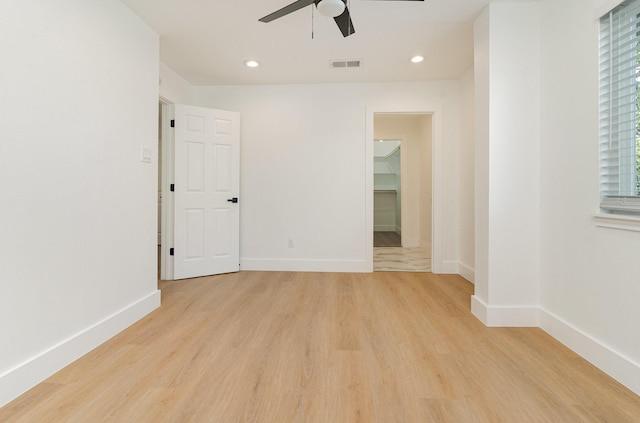 unfurnished room featuring ceiling fan, plenty of natural light, and light hardwood / wood-style flooring