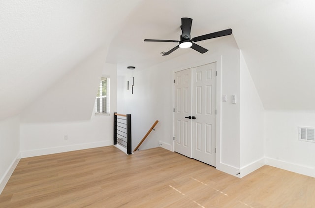 bonus room featuring vaulted ceiling, light hardwood / wood-style floors, and ceiling fan