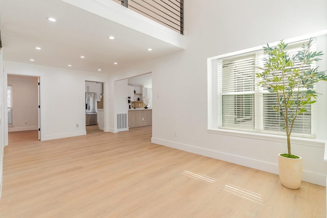 unfurnished living room with light wood-type flooring