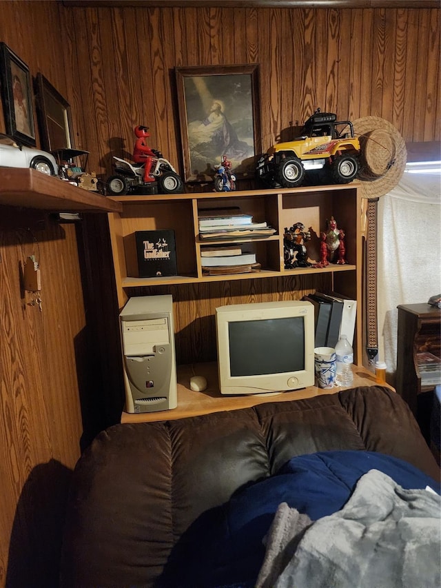 bedroom featuring wooden walls