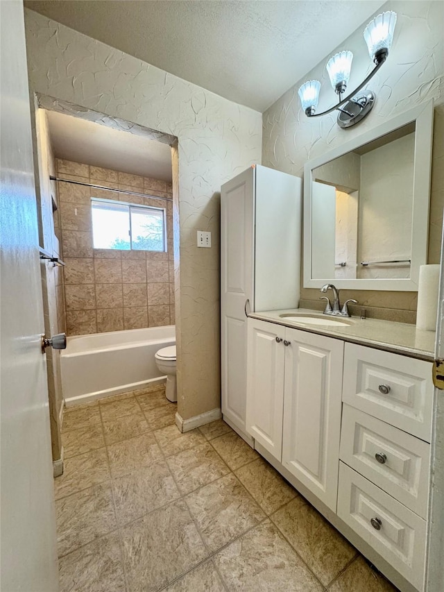 bathroom with a textured ceiling, toilet, shower / bath combination, vanity, and baseboards