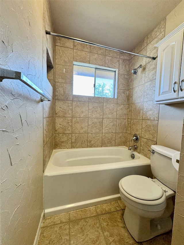 full bathroom with toilet, shower / bath combination, and a textured wall