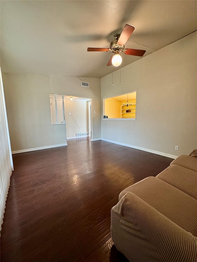 living room featuring ceiling fan, wood finished floors, visible vents, and baseboards