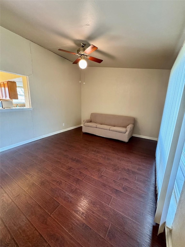 unfurnished room with dark wood-style floors, ceiling fan, and baseboards