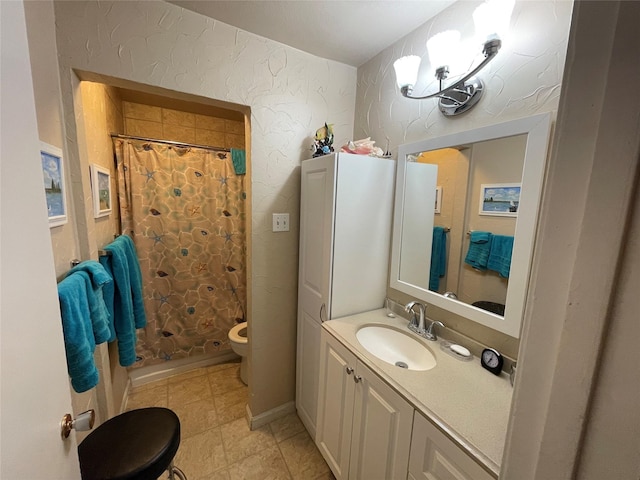 bathroom with toilet, vanity, and walk in shower