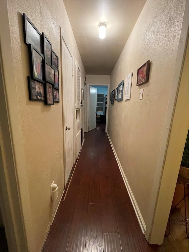 hall with dark hardwood / wood-style floors