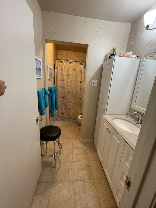 bathroom with toilet, vanity, and curtained shower