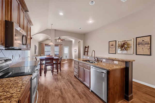 kitchen featuring sink, pendant lighting, dark hardwood / wood-style flooring, and stainless steel appliances