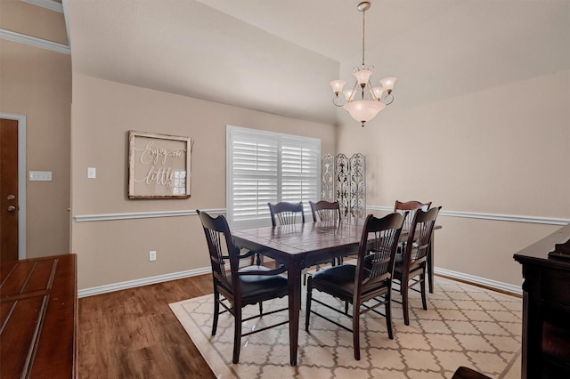 dining room with an inviting chandelier and light hardwood / wood-style flooring