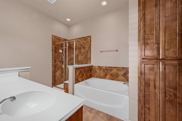 bathroom featuring tile patterned floors, separate shower and tub, and vanity