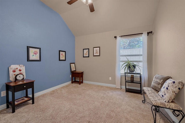 sitting room with ceiling fan, light colored carpet, and lofted ceiling