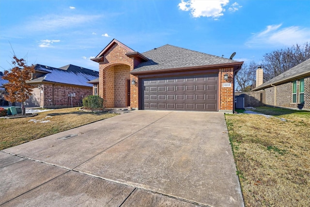 view of front of house with a garage and a front yard