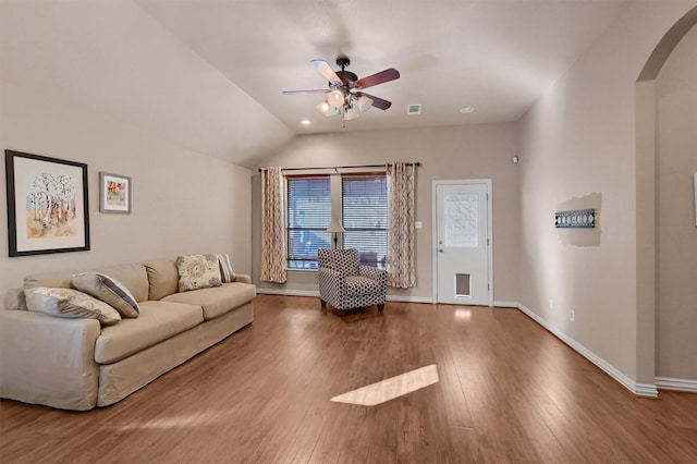 living room featuring ceiling fan, wood-type flooring, and lofted ceiling