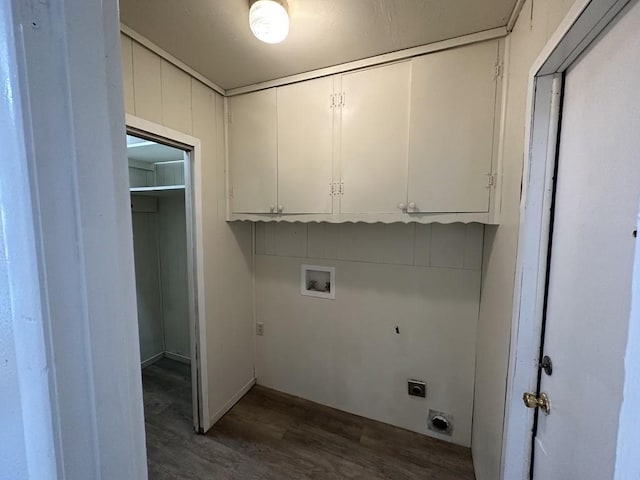 laundry room featuring dark wood-type flooring, hookup for an electric dryer, hookup for a washing machine, and cabinets