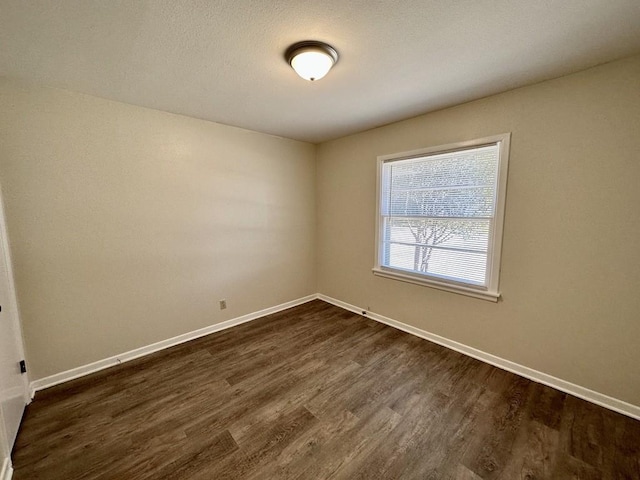 empty room with dark hardwood / wood-style floors