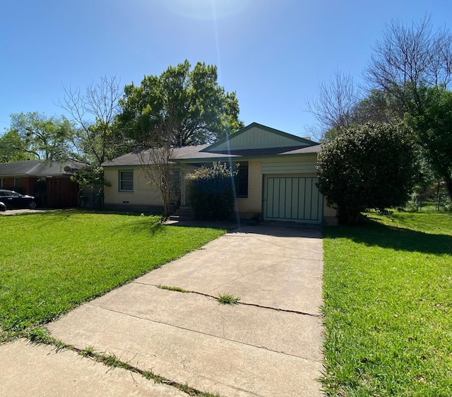 ranch-style home with a garage and a front lawn