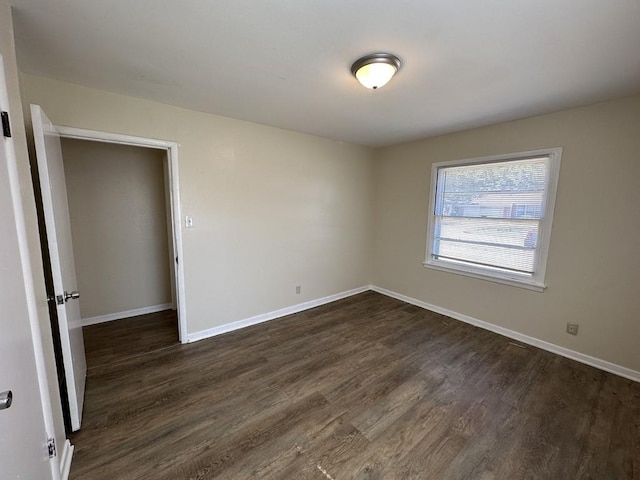 unfurnished room featuring dark hardwood / wood-style floors