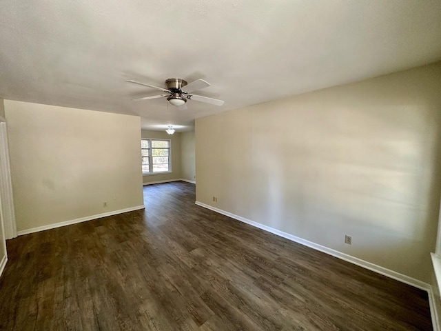 spare room featuring ceiling fan and dark wood-type flooring