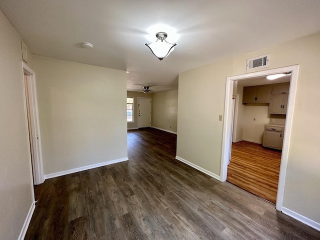 spare room featuring ceiling fan and dark hardwood / wood-style floors