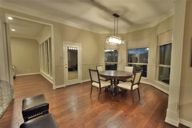 dining room with dark hardwood / wood-style flooring and ornamental molding