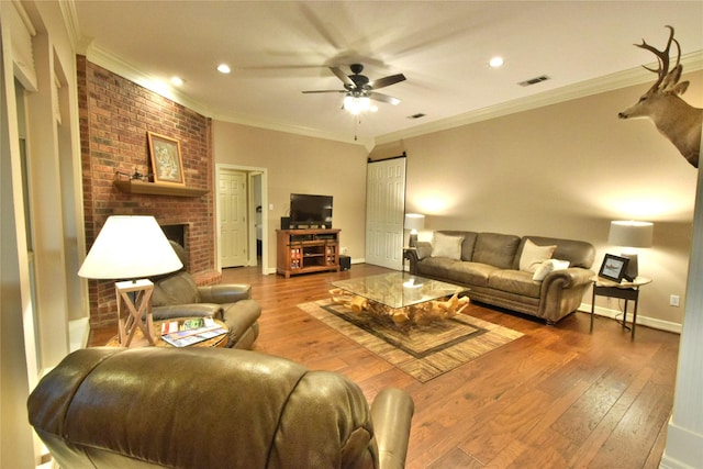 living room with ceiling fan, wood-type flooring, and crown molding