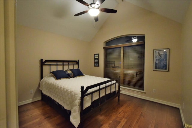 bedroom with ceiling fan, vaulted ceiling, and dark wood-type flooring