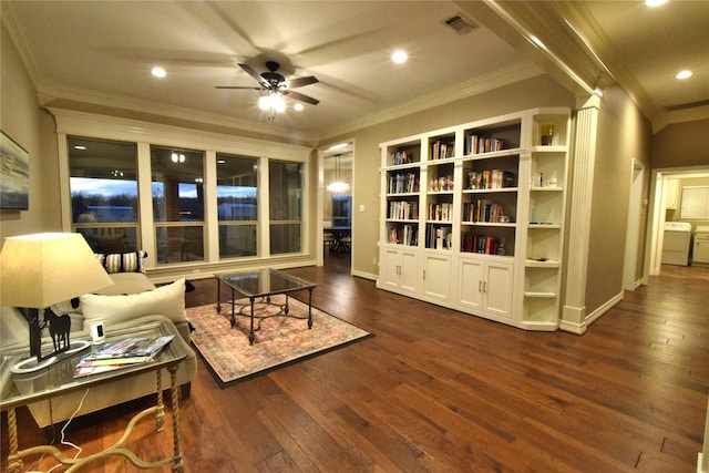 living area featuring ceiling fan, dark hardwood / wood-style floors, washer / dryer, and ornamental molding