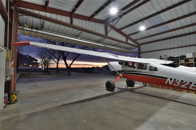 view of garage at dusk