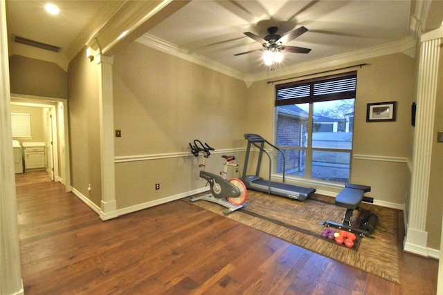 exercise room featuring ceiling fan, washer / clothes dryer, dark hardwood / wood-style floors, and ornamental molding