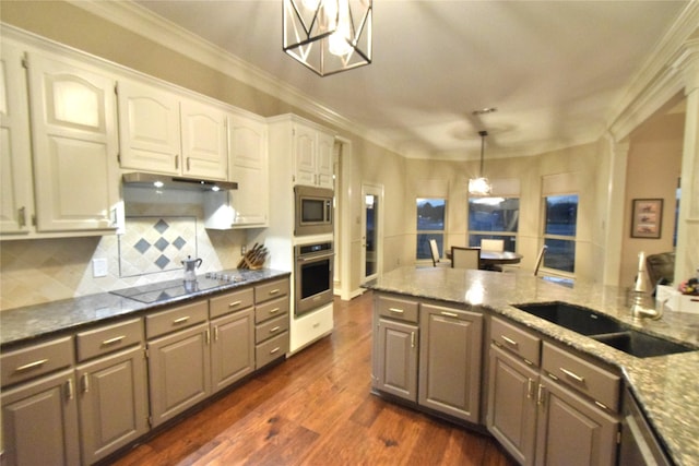 kitchen featuring stainless steel appliances, decorative backsplash, decorative light fixtures, white cabinets, and sink